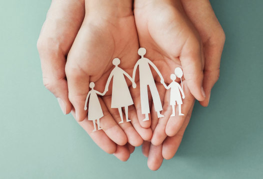 Hands holding paper family